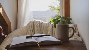 Open journal and pen resting on a cozy blanket during a tech-free retreat